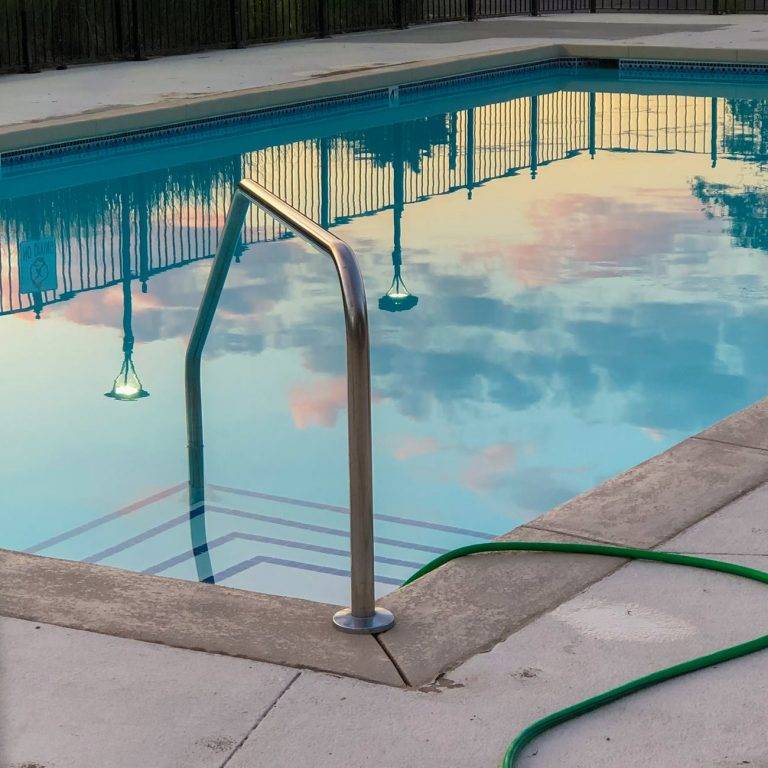 outdoors swimming pool reflecting clear blue sky