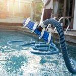 Pool Vacuum cleaning mustard algae out of a pool