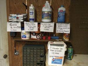 multiple pool chemicals on a shelf