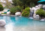 Beautiful-Waterfall-COmes-From-Rocks-On-Pool-With-Blue-Water.jpg