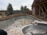 pool view of shallow end and back wall coping in progress.jpg