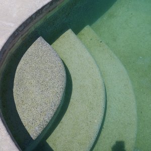 Dirty_pool_steps_uncloudy_water.jpg