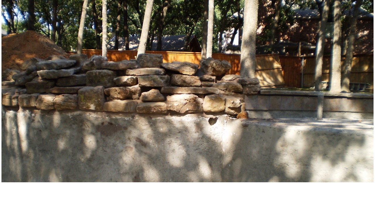 water feature and sun bench taken from inside pool on day 14.jpg