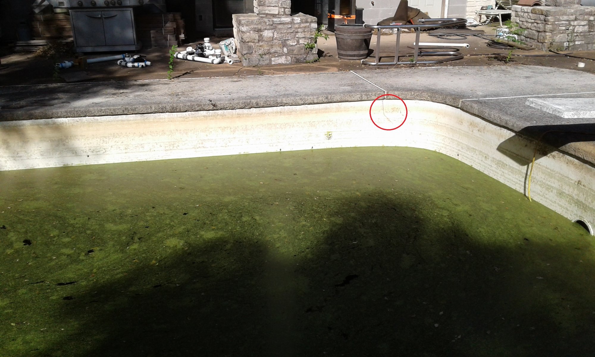 Water level at pool pad floor deep end house side - crack.jpg